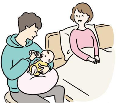 赤ちゃんにミルクをあげるパパ